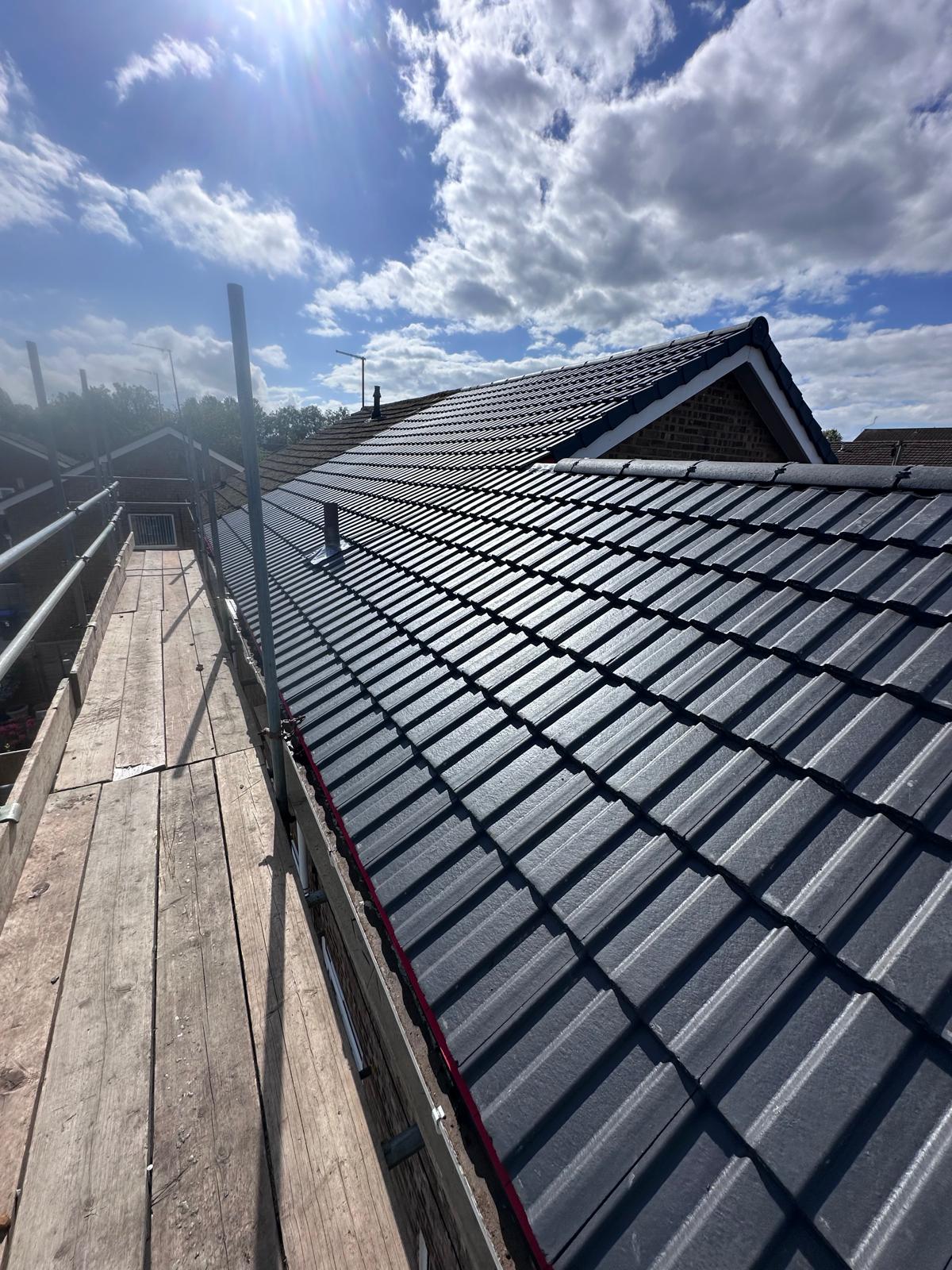 Finished dark tile roof installation